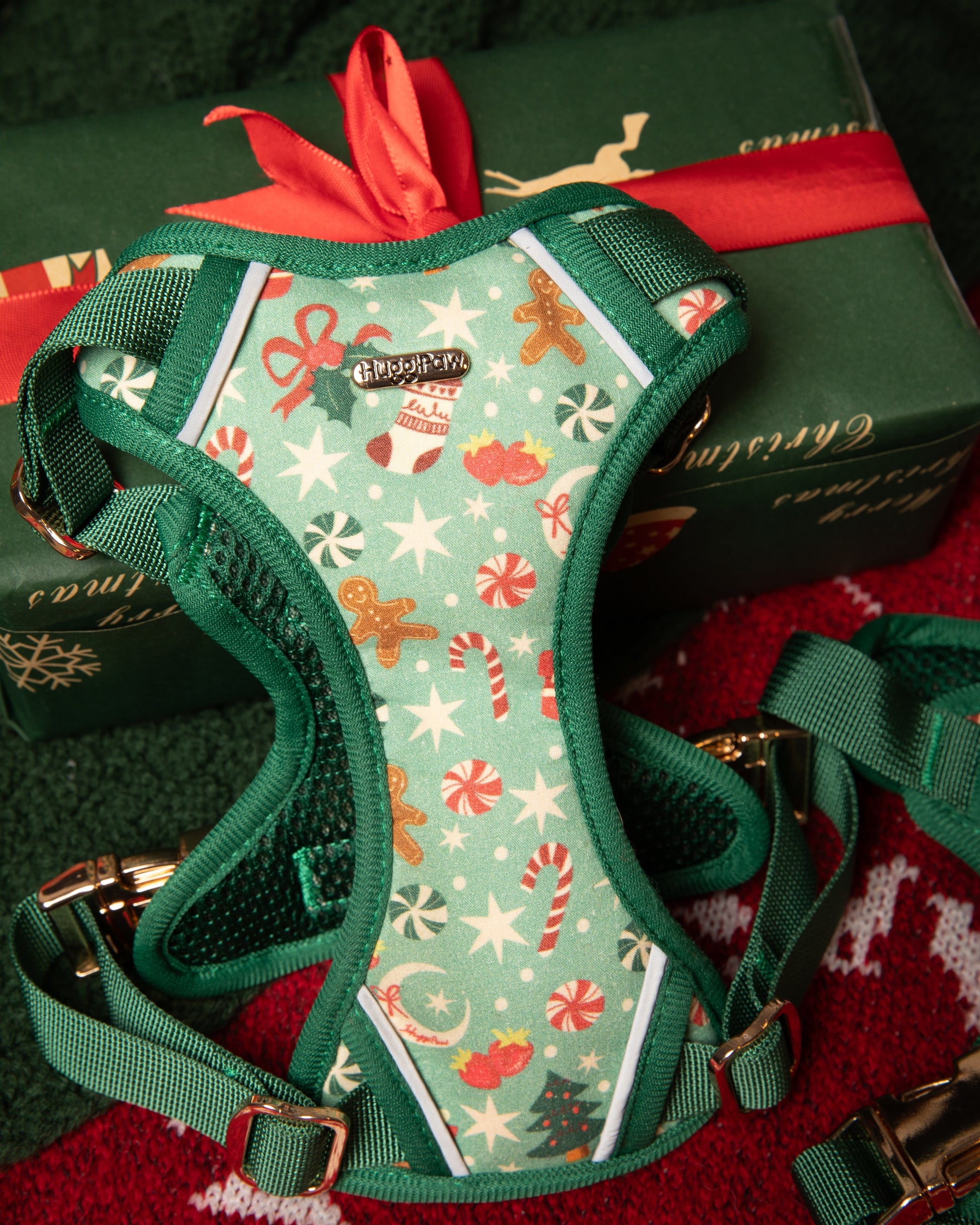 Christmas-themed dog harness on a red and green background with presents.