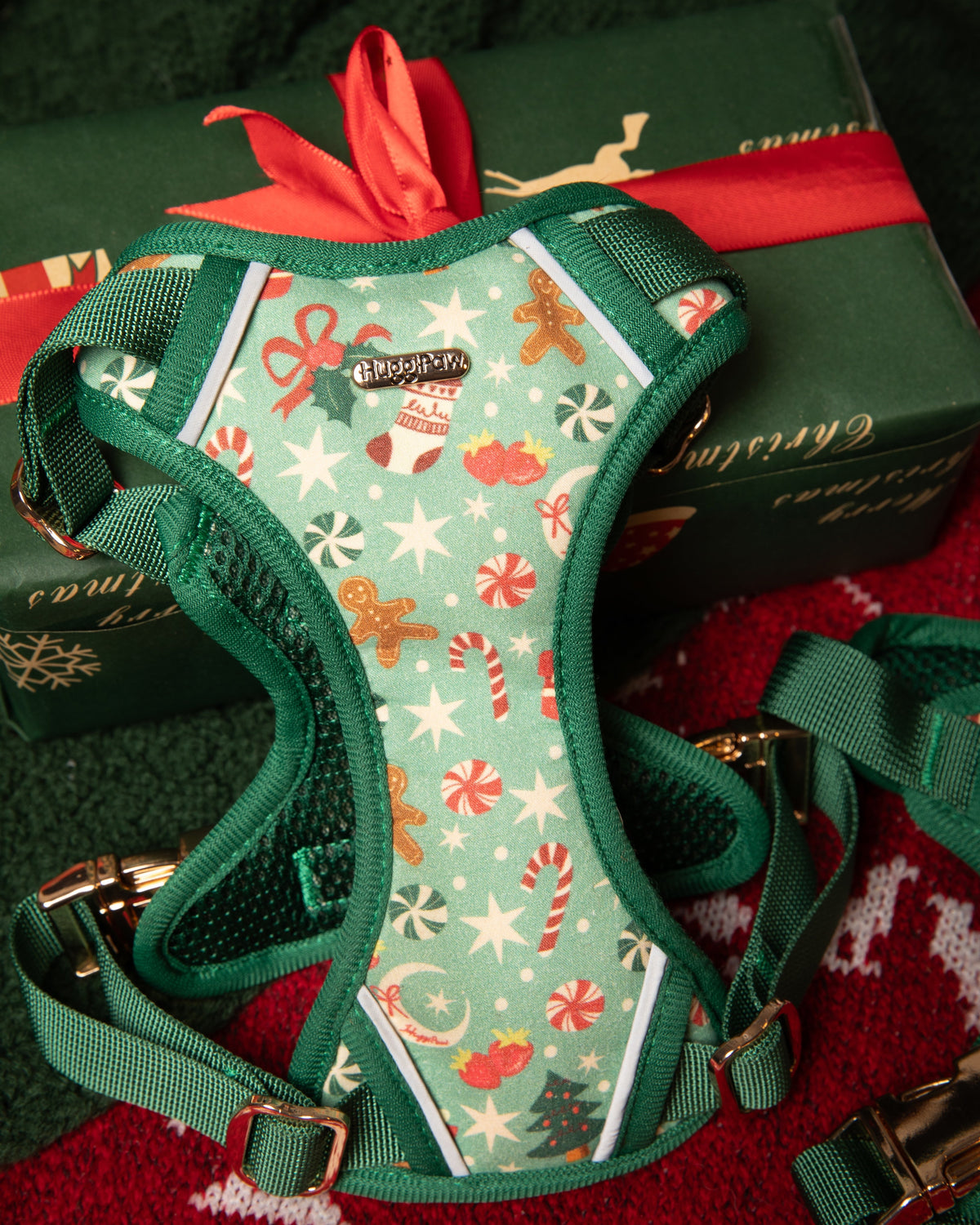 Christmas-themed dog harness on a red and green background with presents.